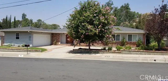 Beautiful curb appeal. Attached garage with direct house access. Concrete driveway with brick ribbons