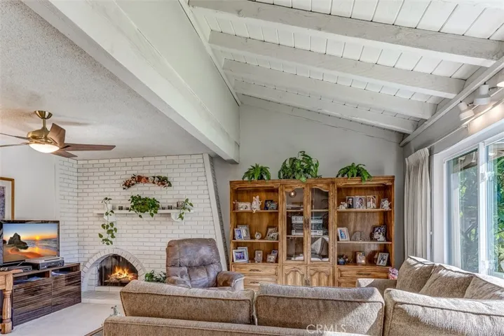 Beamed ceilings greet you as you enter into the bright Living Room