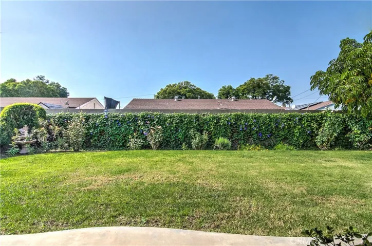 Morning Glory vines, and a pristine lawn create the backdrop for this Park Like Rear Yard! Options to enjoy are endless........
