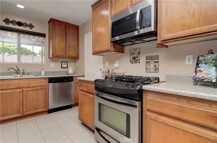 Acres of Counter Space, Fresh Wood cabinets, window over the sink, and Solid Surface counters all spell              
                          D-R-E-A-M   K-I-T-C-H-E-N!