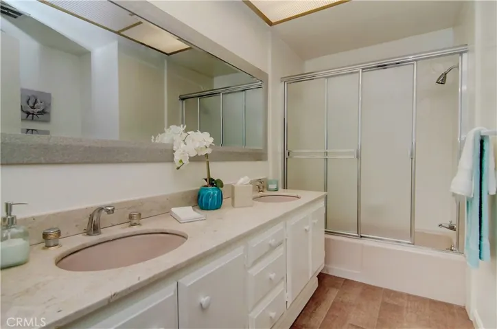 The hall bath is extra generous with dual vanities and compartmentalized commode area.