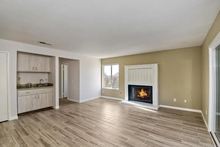 Huge family room is ideal for entertaining or just snuggling by the fire!!  Wet Bar with SS sink!