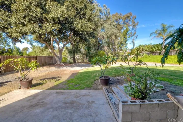 Looking from Family room out to the expansive back yard!  There is a small wire fence but the property extends down into the canyon!!  Great place for kids to plan or a natural for a disappearing pool!