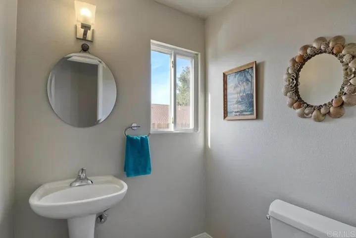 Powder room downstairs features a pedestal sink!