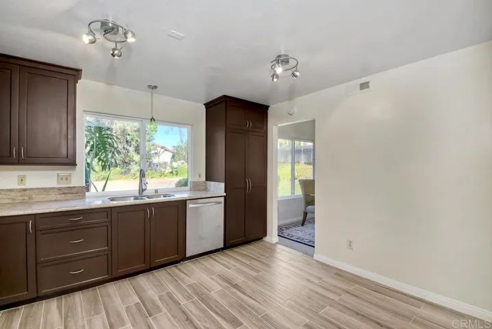 Slab granite counters are enhanced by the Cherry cabinets.