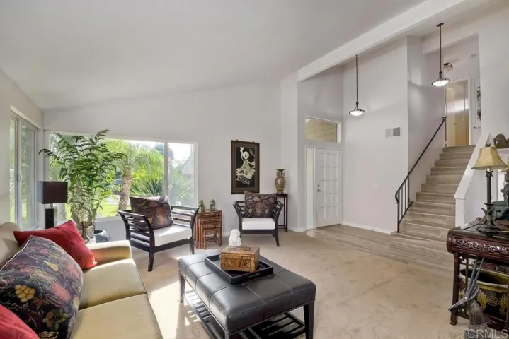This is taken from Dining room toward the Living Room... Please not the "wood grained" tile in entry, kitchen, and Family Room and upstairs to the landing and second bath!