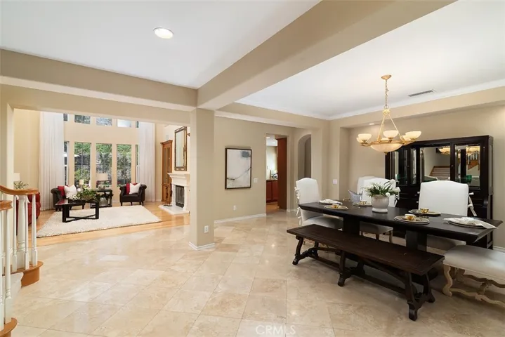 Entry Foyer is spacious with gorgeous flooring and the impressive floor to ceilings windows and open formal dining room.
