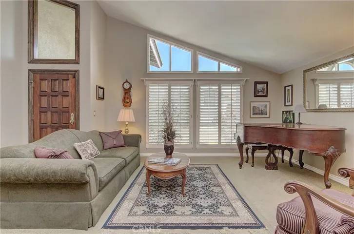 Classic style with nice moldings, plantation shutters and gorgeous front door.