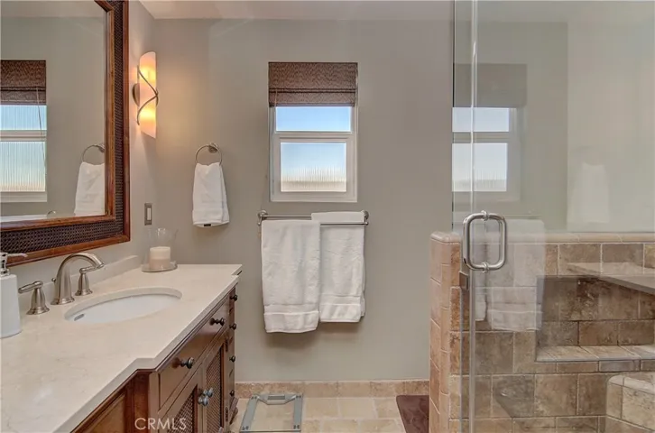 Impeccable master bath with gorgeous vanity and huge custom shower.