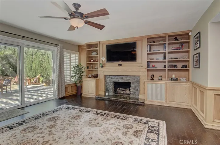 Huge family room opens to covered terrace and has stone fireplace, built-in shelves and storage galore! What a great place to entertain...or just hang out.