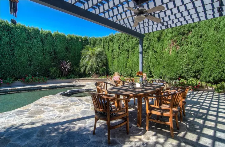 What a great outdoor dining space...this arbor is amazing!
