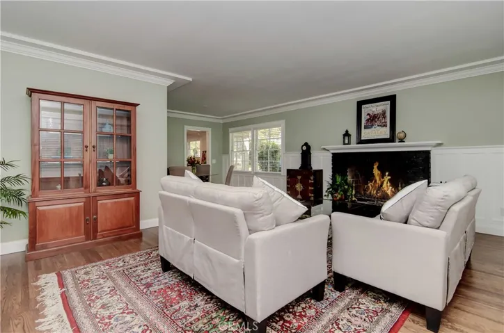 Contemporary meets Classic with tray ceiling detail, custom moldings and wainscotting, wood burning fireplace and gleaming original hardwood floors.