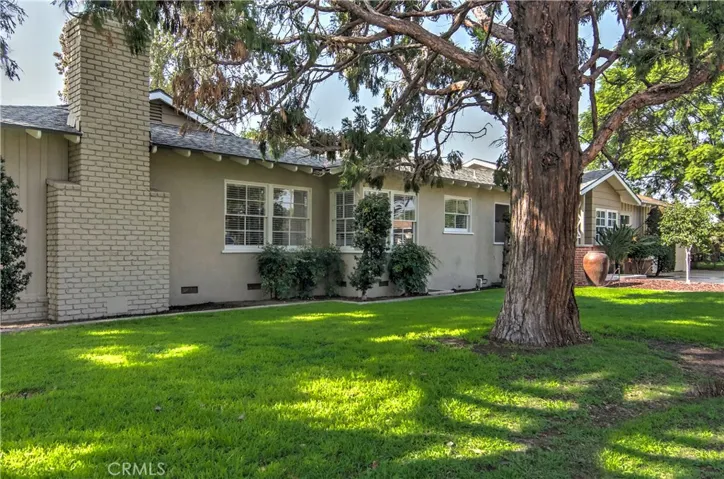Beautiful, mature trees and landscape enhance this oversize corner lot.