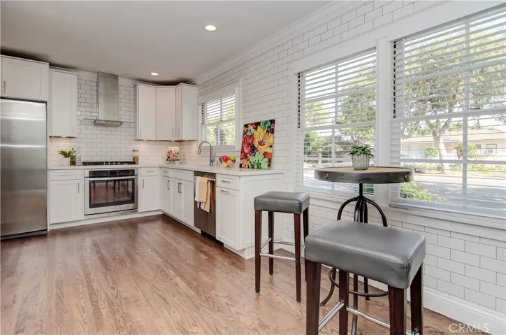 So many beautiful details here...quality all wood cabinetry, quartz counters, stainless appliances, subway tile walls and this breakfast nook with sunny morning view!