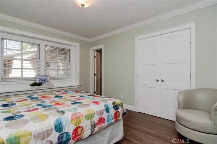 Master suite displays more great details including designer moldings and doors, plus peaceful view to back yard.