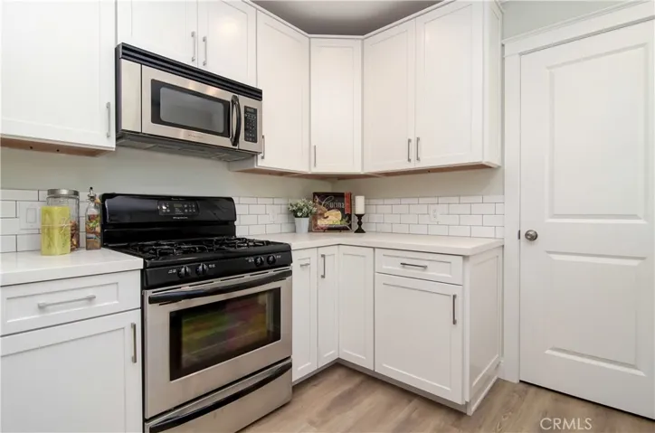 More prep and cabinets in apartment kitchen...door leads to laundry room...everything in-laws, guests or tenants could want!