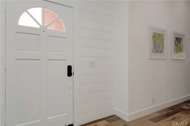 Separate entry foyer and hallway create a nice welcome and transition between living and sleeping spaces. Contemporary ship lap details add designer touch.