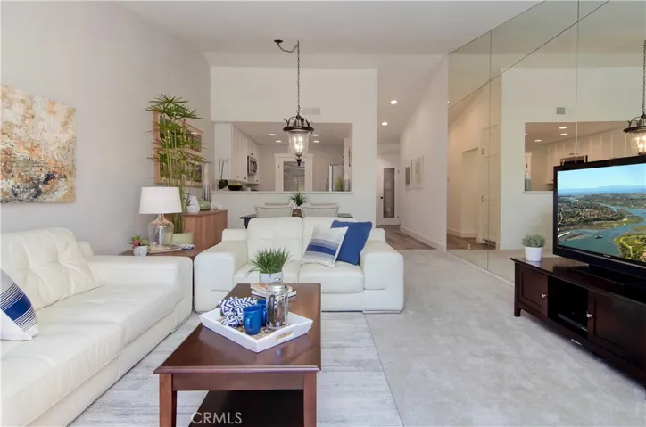 Vaulted ceilings and mirrored wall add extra volume to living space.