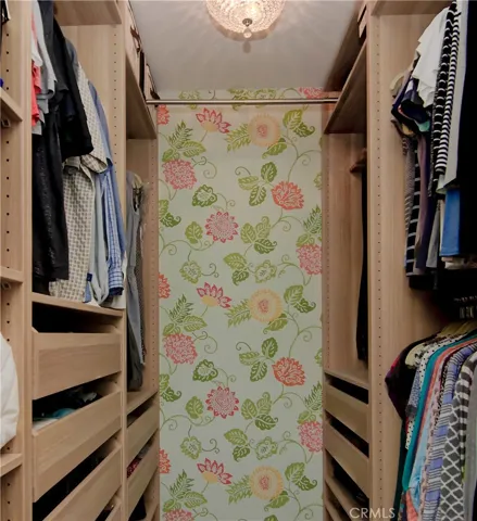 These built-ins in roomy walk-in closet will keep anyone organized!