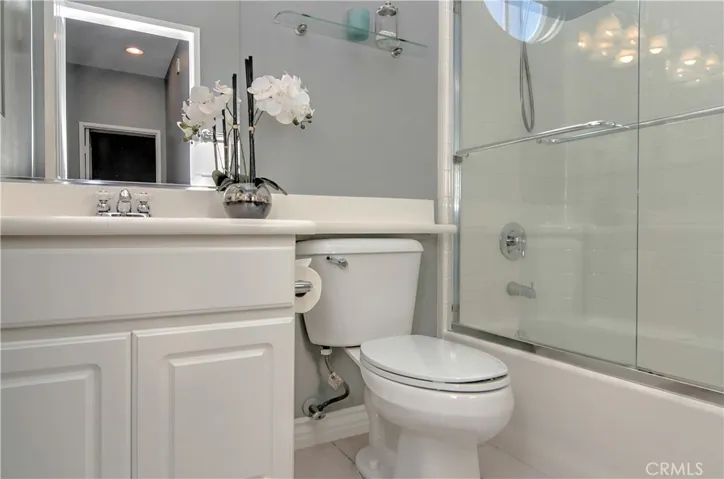 Sparkling guest bath has contemporary fixtures and details.
