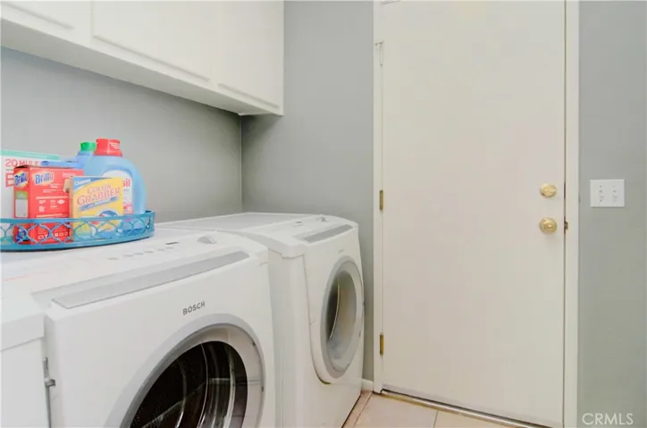 Convenient laundry room has extra storage and access to two car garage.
