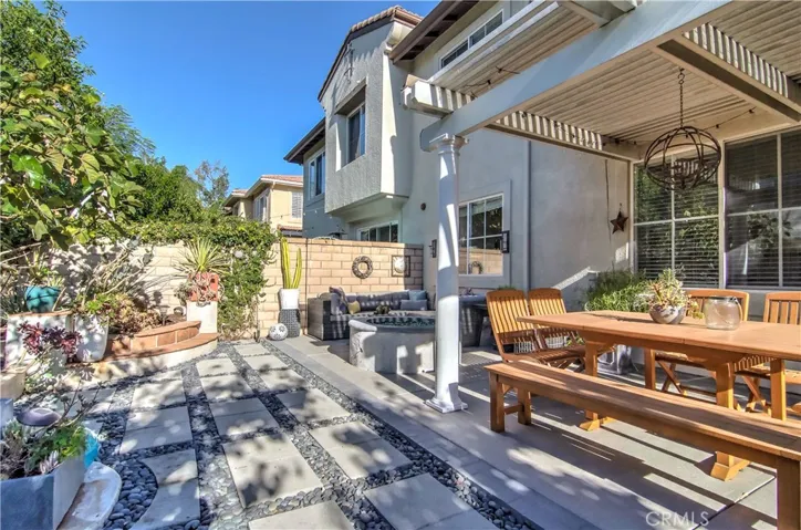 Covered dining area, cozy lounge area, fountain and raised planters for the gardener in you...doesn't get much better than this!