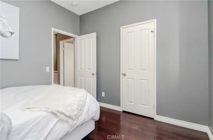 Secondary bedroom has walk-in closet, hardwood flooring and nice moldings.