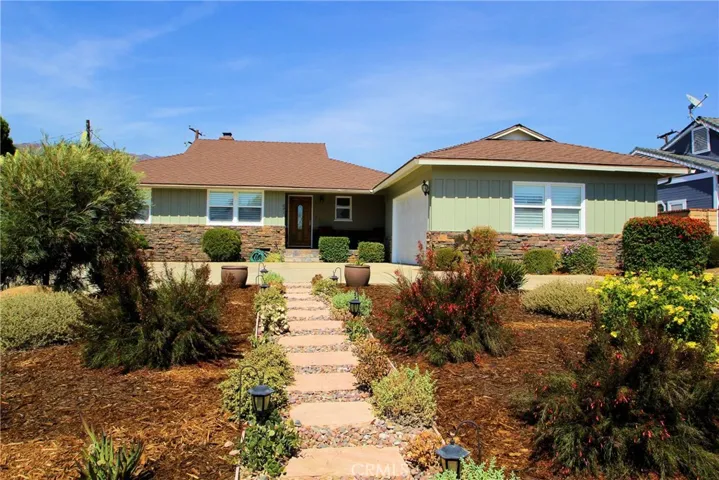 Front of House with circular driveway and low maintenance yard