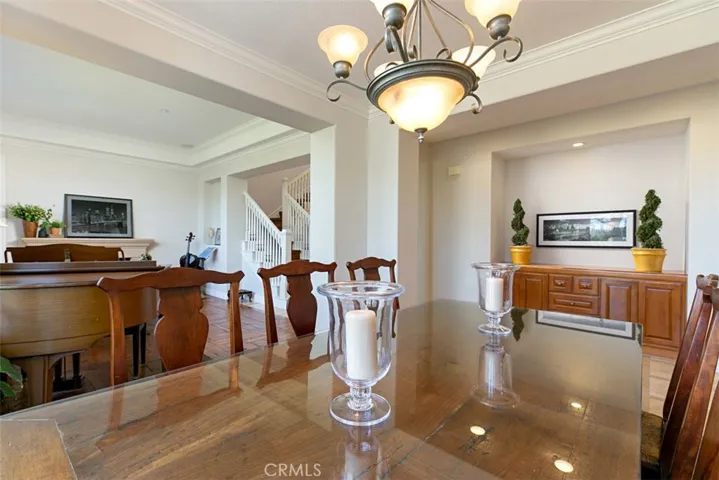 Dining Room with built-in cabinetry flowing into the Living Room and Formal Entry