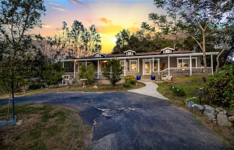 Authentic Country Farmhouse, with covered front porch that expands the length of the house. French doors lead into the great room and deluxe bedroom. Sit a spell and enjoy the sunset.
