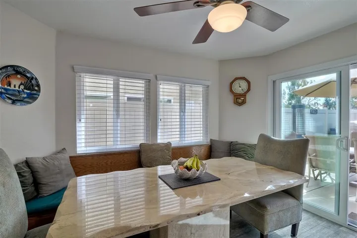 The adjacent breakfast nook features a custom built-in seating bench.  Table is available for purchase outside of escrow.