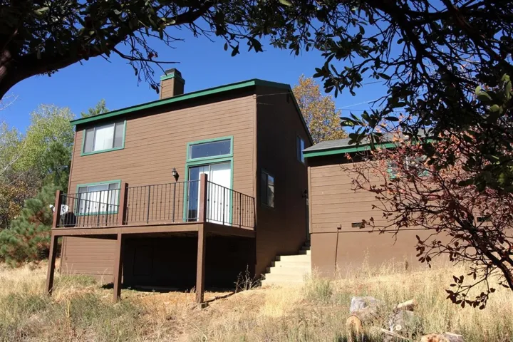 Deck off living room faces large back yard.