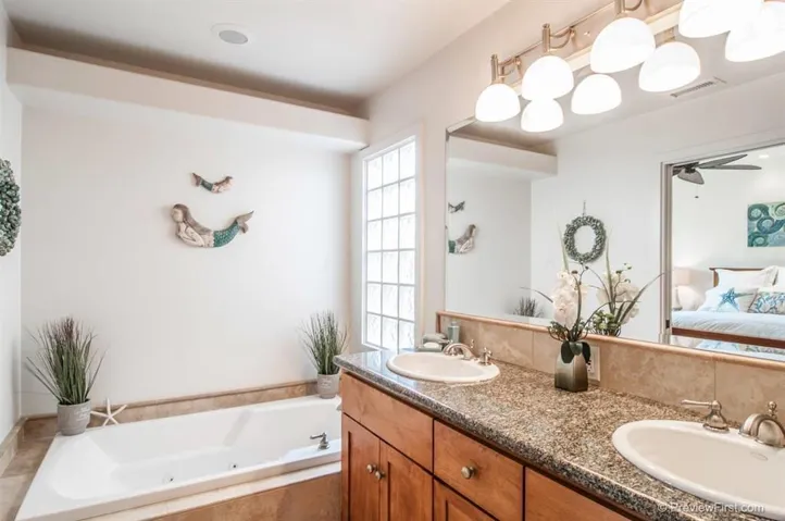The ensuite master bath has a relaxing jetted tub, tumbled travertine shower, dual sinks, travertine floors and beautiful granite countertops.