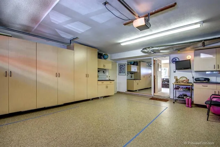 Nicely finished 2-car garage with custom storage, laundry and epoxy floors