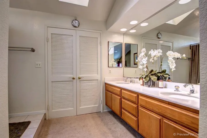 En Suite Master Bath with separate w/c, walk in closet, dual sinks, and vaulted ceiling with skylight.