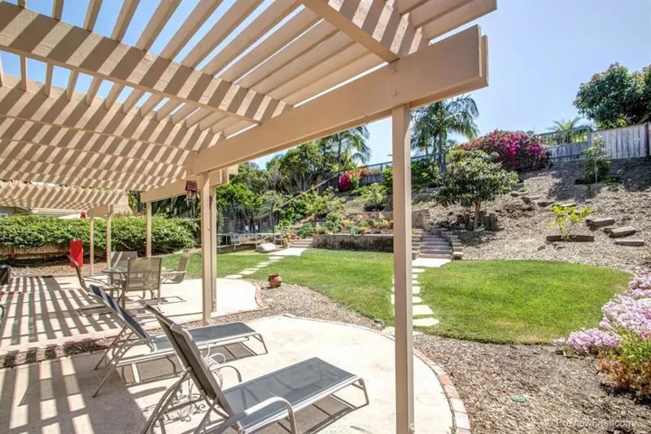 Three patio spaces off the back of the home create zones for entertaining, dining and play