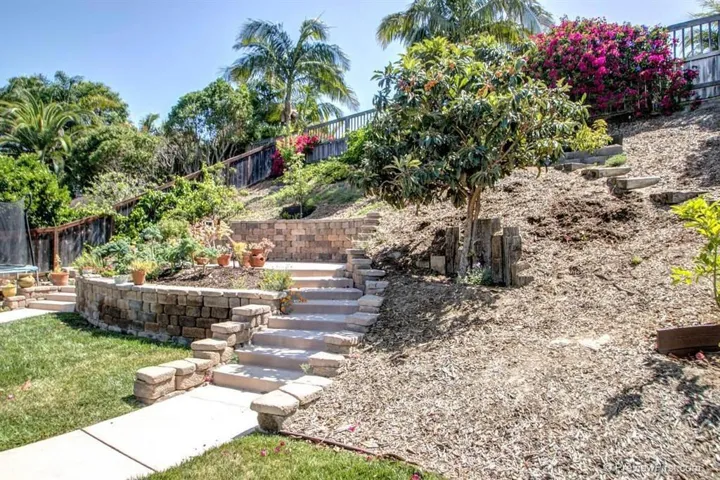 Terraced 4th patio maximizes space creating room for garden beds, 7 fruit trees, and more