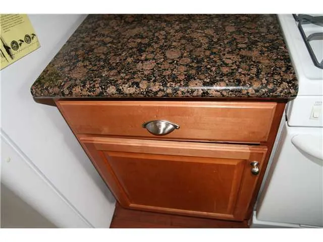 Beautiful granite kitchen countertops, stylish hardware on custom cabinetry