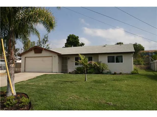View of entry plus side yard, depth to show ample driveway parking, possible RV parking to left of driveway.