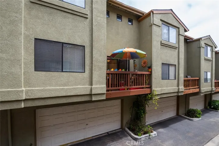 Rear view of property highlighting balcony and spacious 2 car garage.
