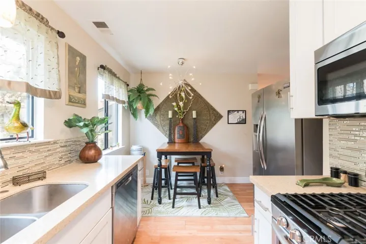 Nice sized dining space with designer lighting fixture.