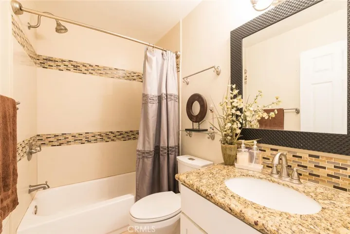 Upper bathroom located in between bedrooms 2 and 3.  Granite countertops, tiled backsplash and combo shower/tub.