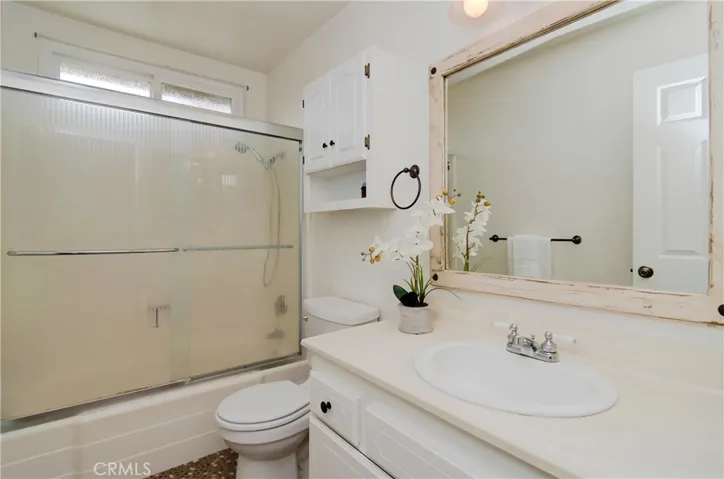 Sparkling upstairs hall bath is centrally located to guest/kids rooms and has cool pebble flooring.