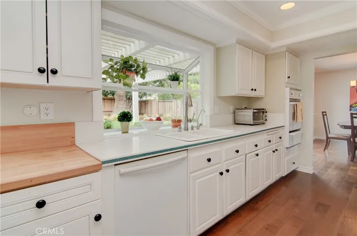 Nice appointments here with loads of bright white cabinetry, corian counters, recessed lighting and built-in appliances.
