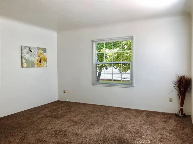 Living room with coved ceilings and dual pane windows.