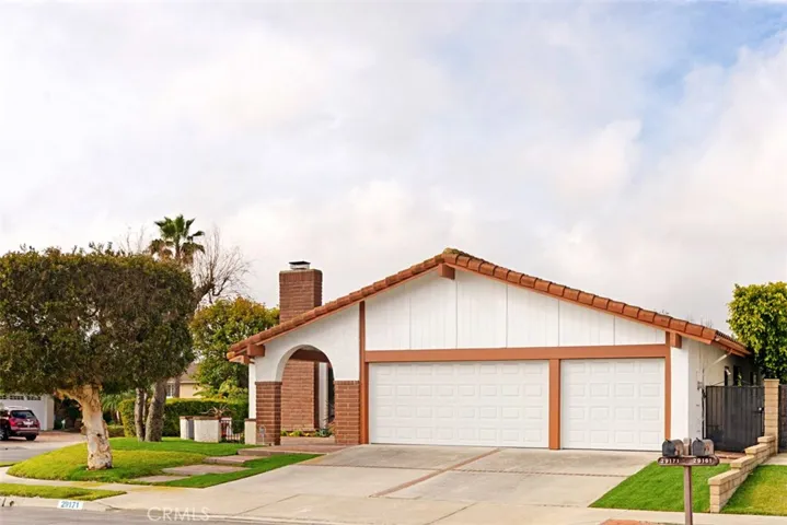 Front shot of this private corner location with 3 car garage and generous driveway, all on a culdesac street