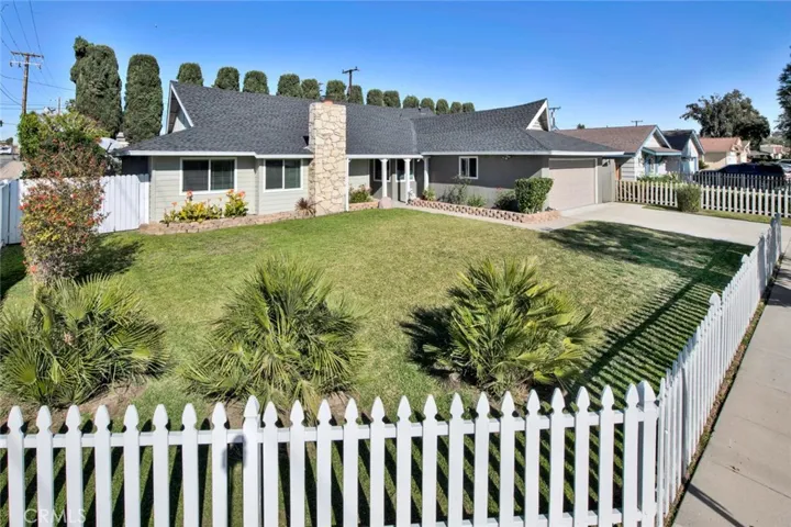 FRONT OF HOME WITH PICKET FENCE
