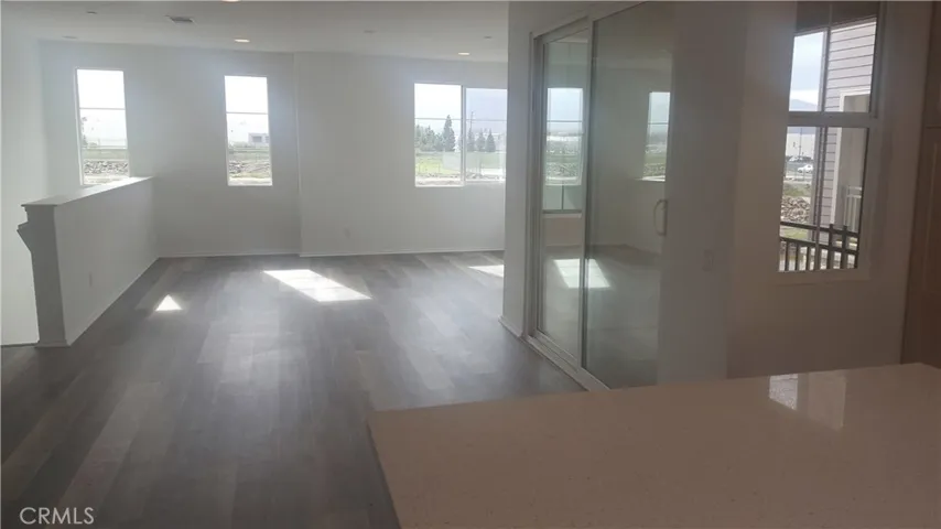 Sunny Great Room with view, beautiful vinyl plank flooring and private deck.