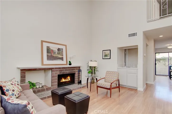 Living room has it all...high vaulted ceilings, hardwood flooring, fireplace and wet bar.  Great space for family or entertaining.