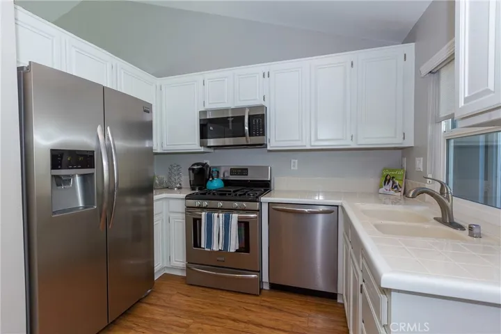 Spacious kitchen with stainless appliances and lots of cabinets.